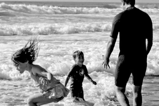 A family having a fun time at the Radhanagar Beach