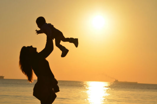 A woman playing with her child at Radhanagar Beach