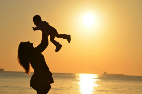 A woman playing with her child at Radhanagar Beach