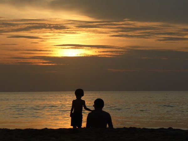 A father and his son enjoying the sunset from Radhanagar Beach