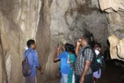 Visitors exploring the limestone cave in Baratang