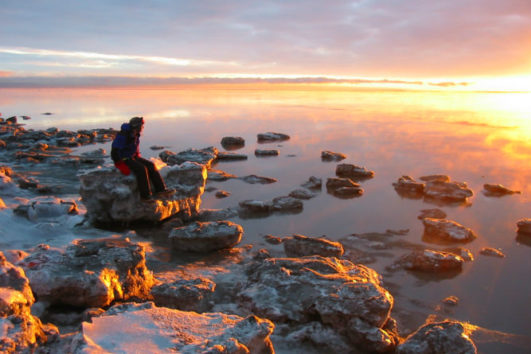 A backpacker watching the sunset at Havelock