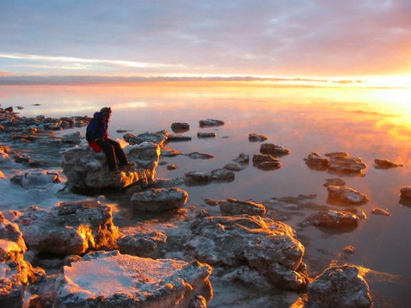 A backpacker watching the sunset at Havelock