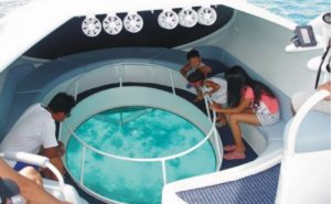 Tourists enjoying a Glass Bottom boat ride in the Andaman